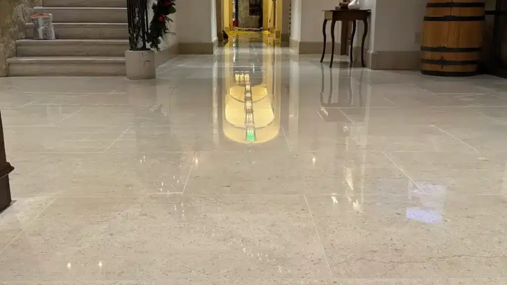 Restored limestone lobby floor with polished finish and light reflections in a country club setting