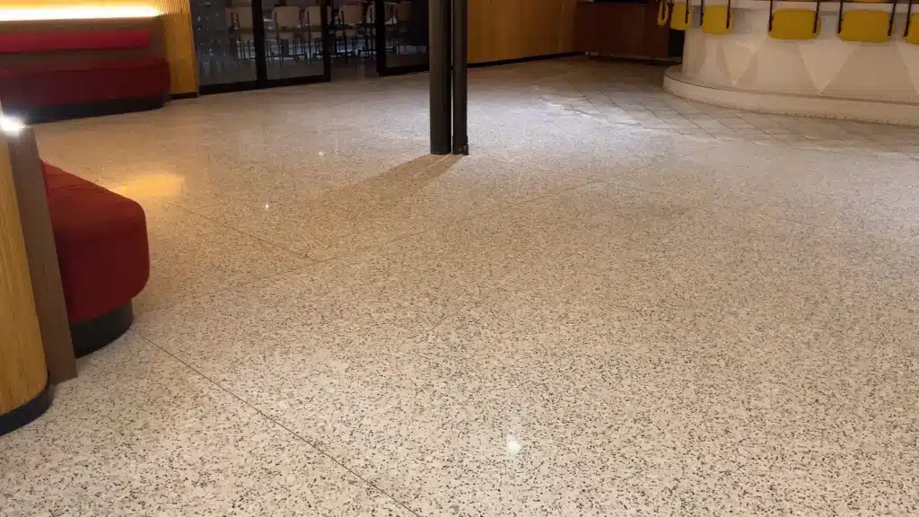 Commercial terrazzo floor before restoration in Bellaire TX showing dull finish and surface wear