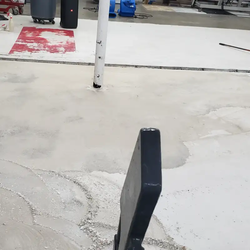 Concrete floor with partially removed paint and coating during professional surface preparation