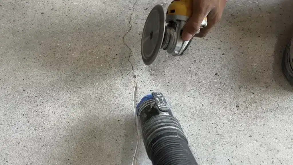 Concrete floor crack repair work in progress to prepare the slab before new flooring installation