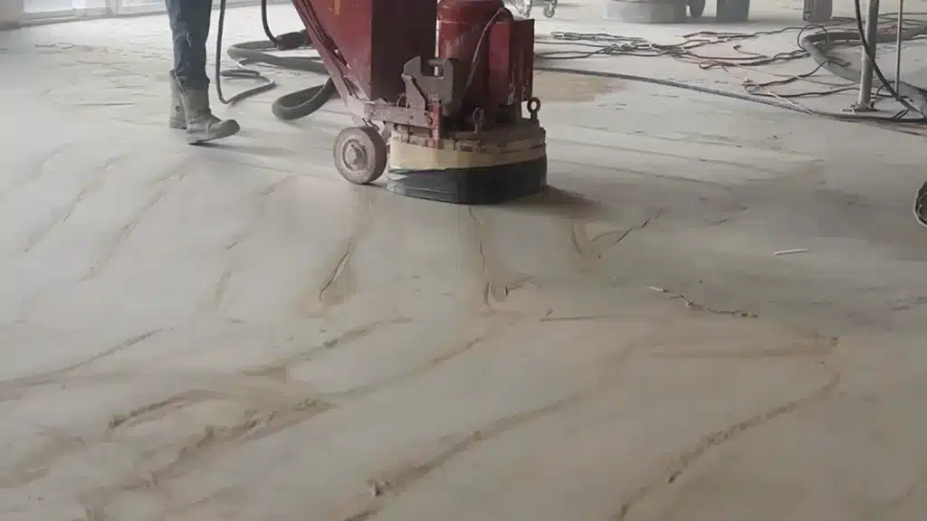 Concrete floor grinding in progress on a commercial slab to prepare the surface for new flooring installation