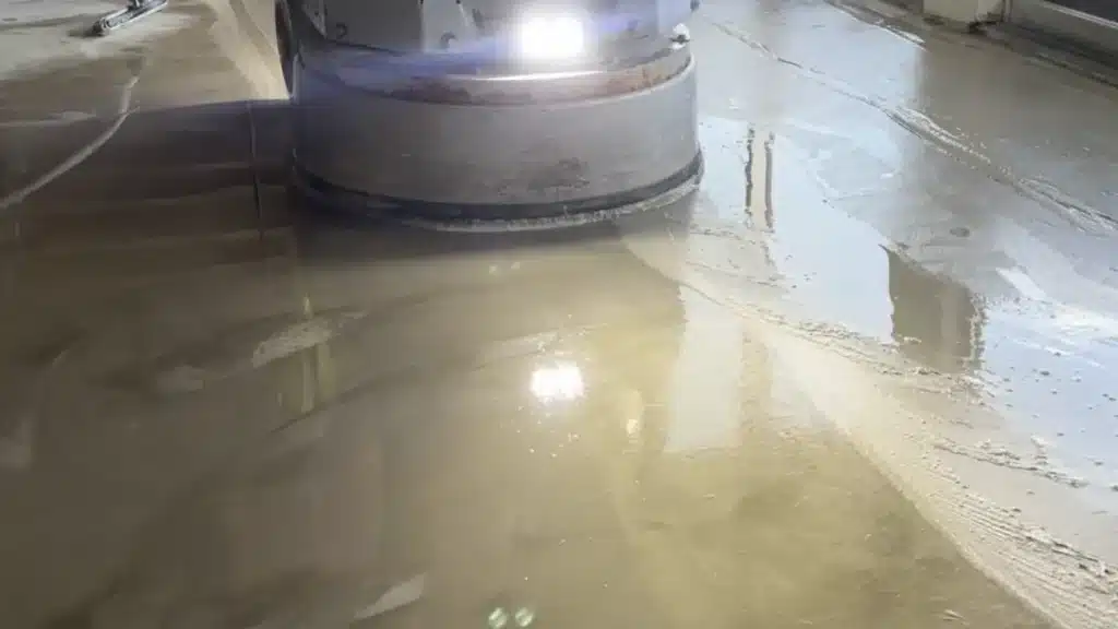 Concrete floor grinding in progress to prepare the surface for new flooring installation