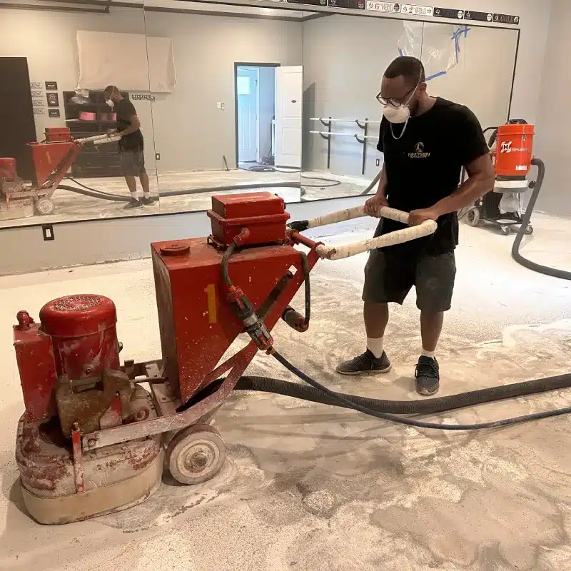 Professional surface grinding to prepare a concrete floor for new flooring installation