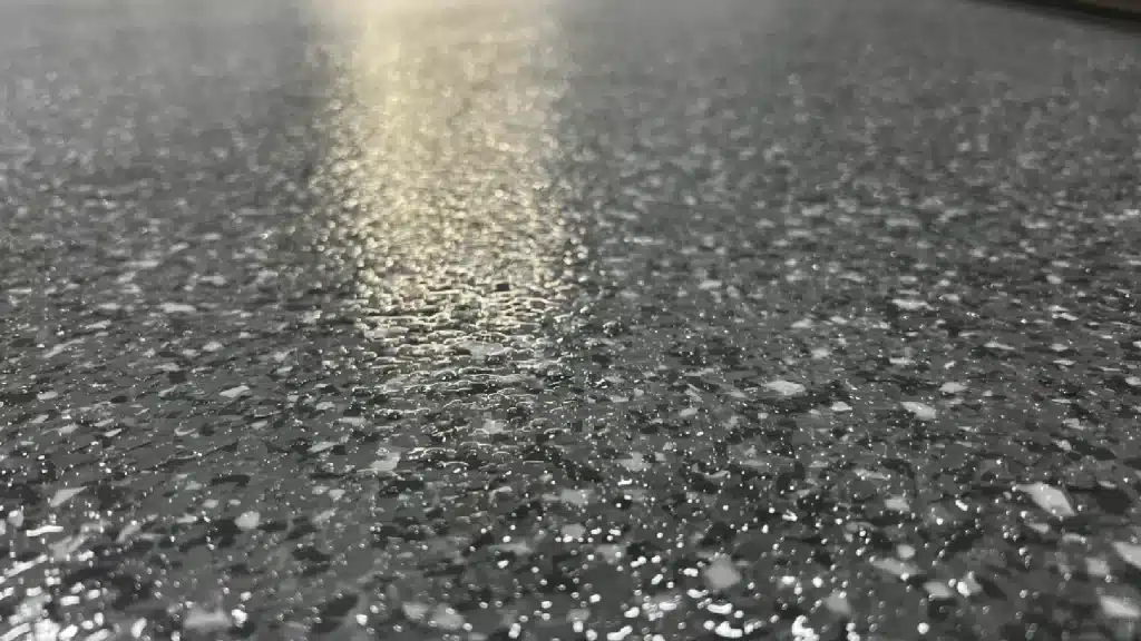 Close-up of epoxy floor coating with flake system and anti-slip polyaspartic finish in Tomball TX