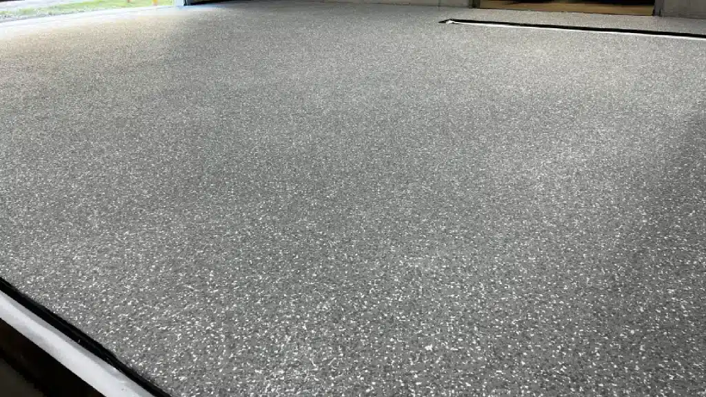 Epoxy floor coating with decorative flake broadcast prior to polyaspartic topcoat in Tomball TX