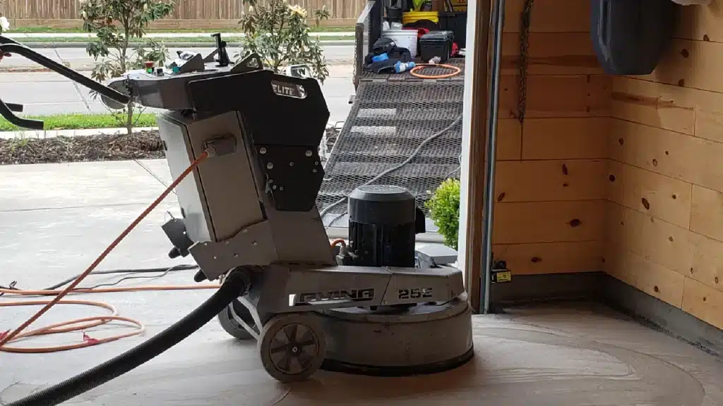 Mechanical grinding of residential garage concrete prior to epoxy floor coating in Houston TX