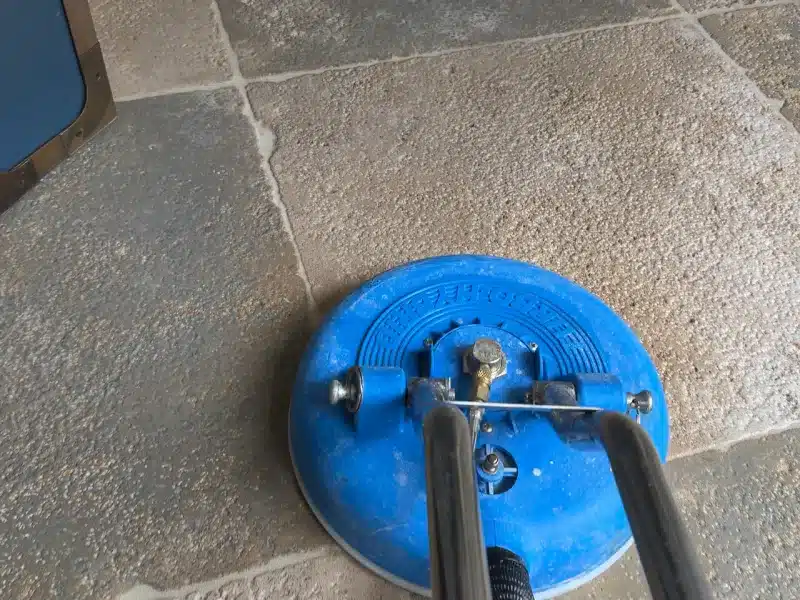 Professional grout cleaning using rotary extraction equipment to remove embedded dirt from tile floors