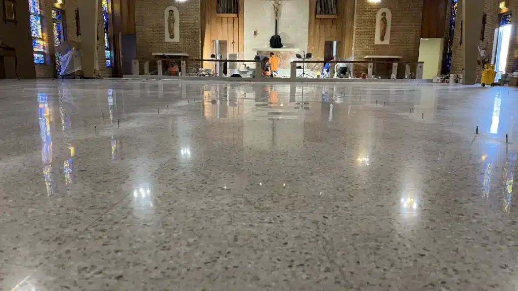 Fully restored terrazzo floor after final polishing inside Immaculate Conception Church in Goliad, TX