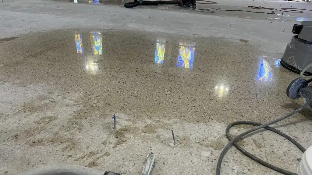 Terrazzo floor test polishing in progress at Immaculate Conception Church in Goliad, TX showing contrast between polished and unpolished areas