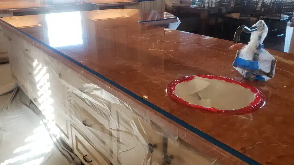 Marble kitchen countertop protected and masked prior to honing during restoration in Kemah, Texas.