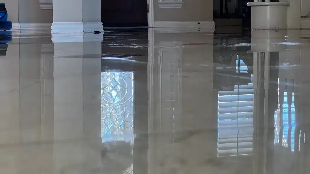 Marble floor in the main entry after restoration, showing a polished finish and clear reflection.