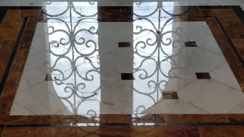 Marble floor after polishing in entry area showing restored high-polish finish and uniform reflectivity.