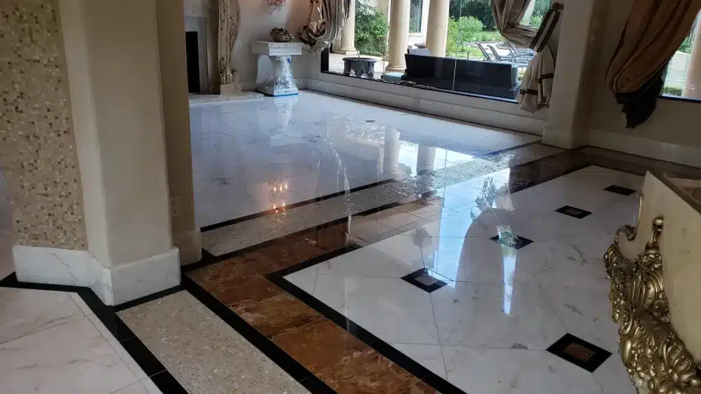 Marble floor after polishing showing restored high-gloss finish and uniform surface clarity throughout the space.