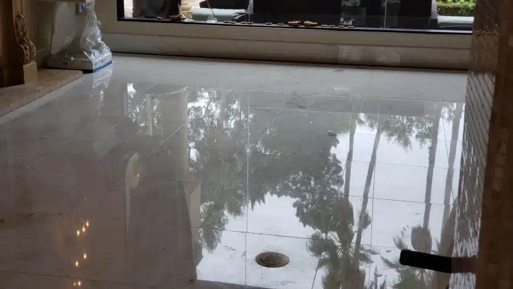 Marble living room floor after polishing showing restored high-polish finish and uniform reflectivity.