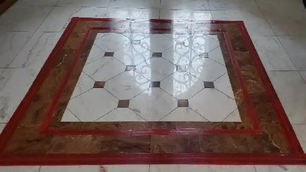 Marble floor before polishing in entry area showing dull finish and surface scratches from heavy traffic.