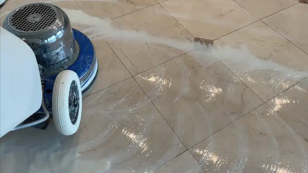 Marble floor polishing in progress showing surface refinement and removal of honing marks in Royal Oaks, Houston, Texas.
