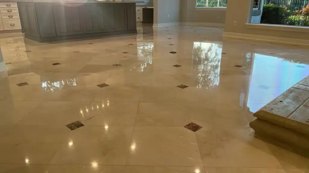 Wide view of restored marble floor showing consistent polish and even reflections across the space in Royal Oaks, Houston, Texas.