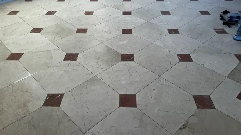 Marble floor during restoration showing repaired and leveled surface before final polishing.