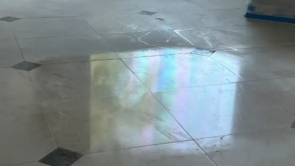 Marble floor with uneven shine and slippery surface caused by a failed prior polishing attempt in Royal Oaks, Houston, Texas.