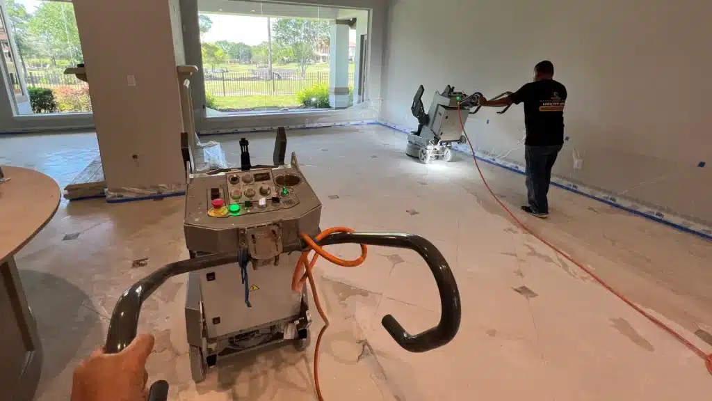 Marble floor restoration in progress showing removal of a slippery surface coating and honing to restore a consistent finish in Royal Oaks, Houston, Texas.