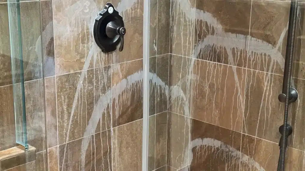 Marble shower before restoration in Memorial TX showing severe etching from improper cleaning product use