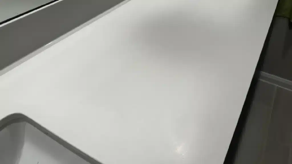 Quartz countertop during honing process after surface dullness was removed and prior to final polishing.