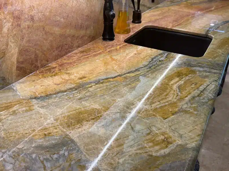 Cleaned quartzite countertop with natural veining and refreshed surface appearance