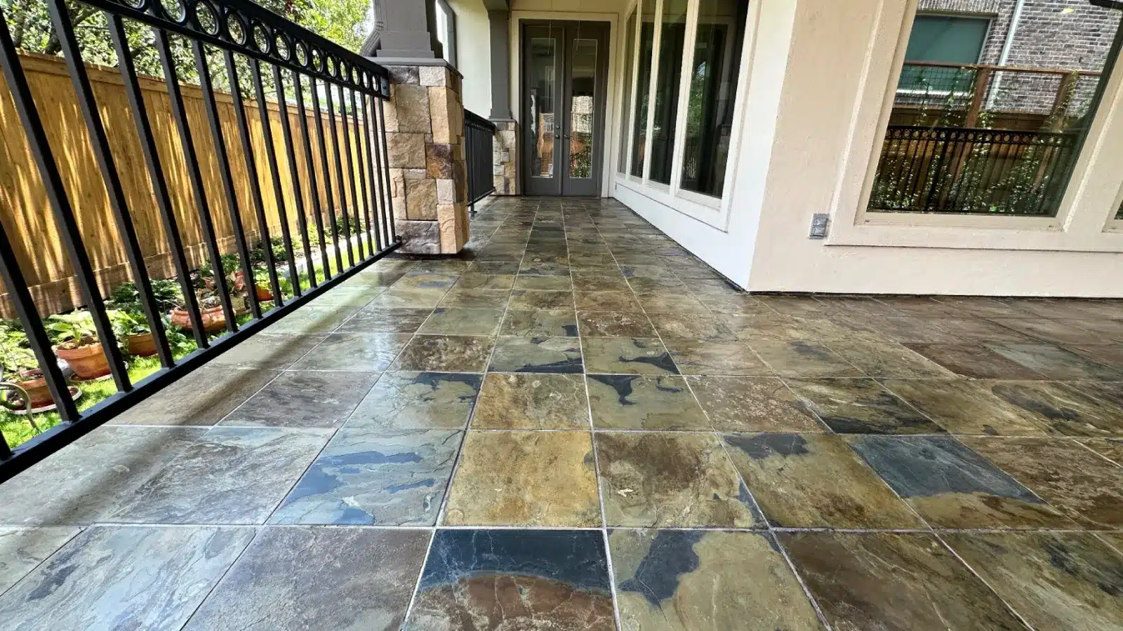 After restoration of an outdoor slate patio floor showing restored color, enhanced finish, and uniform grout lines.