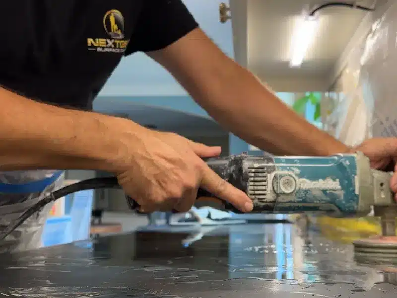 Technician honing and polishing a soapstone countertop surface