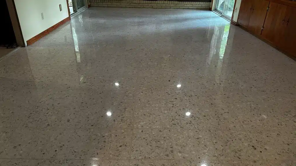 Restored terrazzo living room floor with a high-gloss finish after professional restoration in Goliad, TX