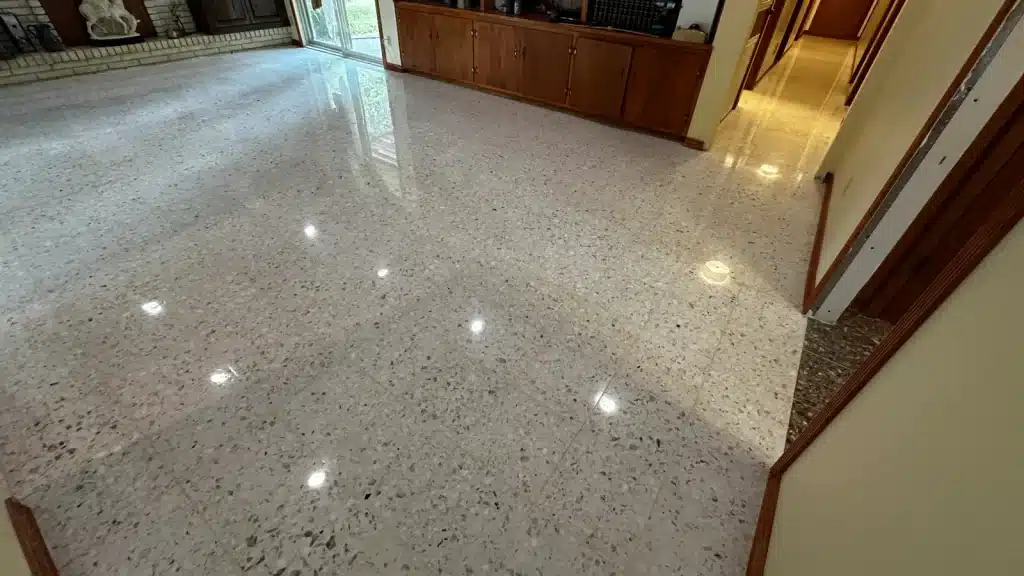 Fully restored terrazzo floors in living room and hallway with a high-gloss finish in Goliad, TX