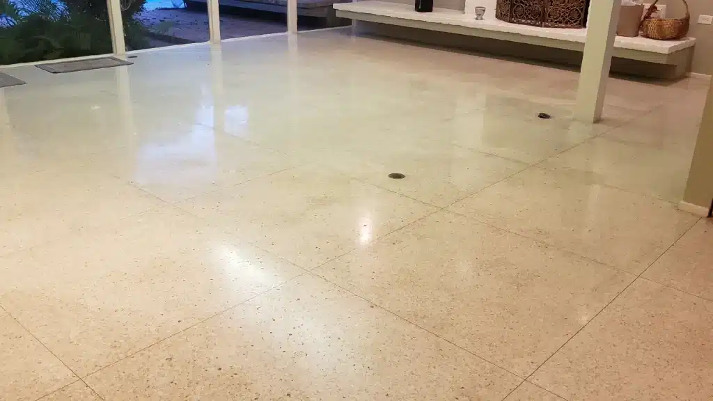Terrazzo floor in living room near kitchen before wax removal and repair in Richmond TX