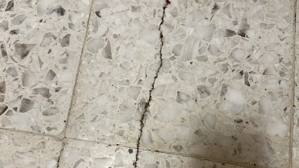 Terrazzo floor crack running across hallway before restoration in Goliad, TX