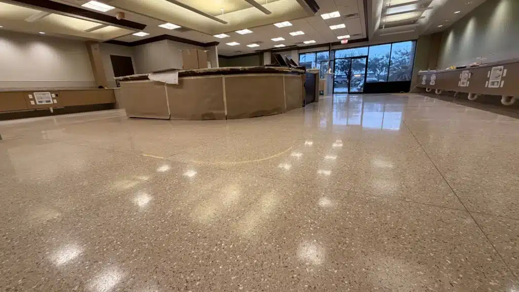 Epoxy terrazzo floor in entry area after semi-gloss restoration in Pearland TX medical facility
