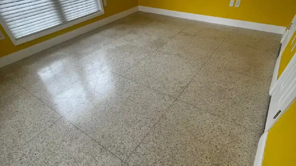 Terrazzo floor with heavy wax buildup and moisture-related sweating in Lake Jackson TX