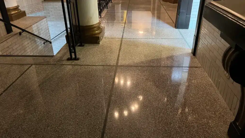 Wide view of restored terrazzo floor with uniform finish and clear light reflection in a Downtown Houston building.