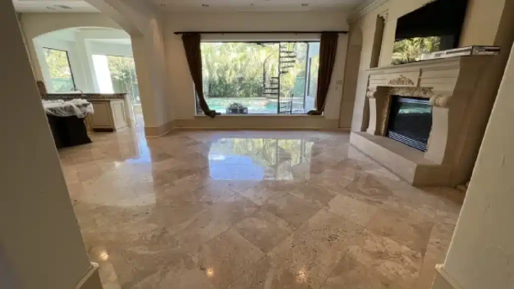 Travertine living room floor after polishing showing a uniform reflective finish and improved surface clarity.