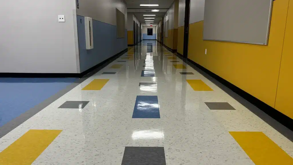 VCT floor after clean and coat service in a commercial school hallway