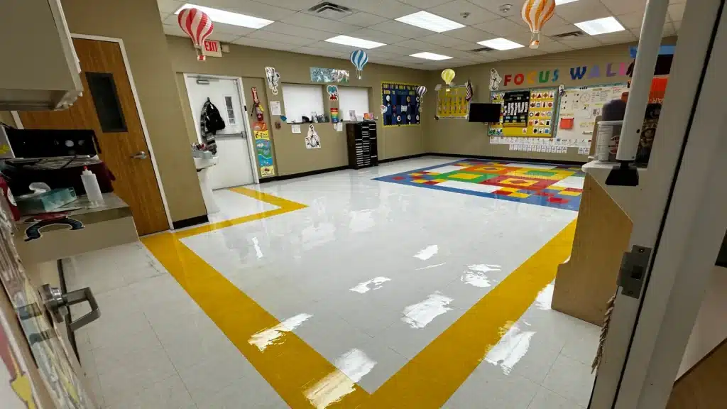 Ongoing VCT floor maintenance program in a daycare classroom with high-gloss finish