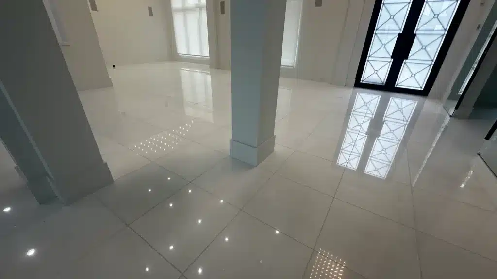 Restored White Thassos marble floor in the entry area showing a uniform polished finish.