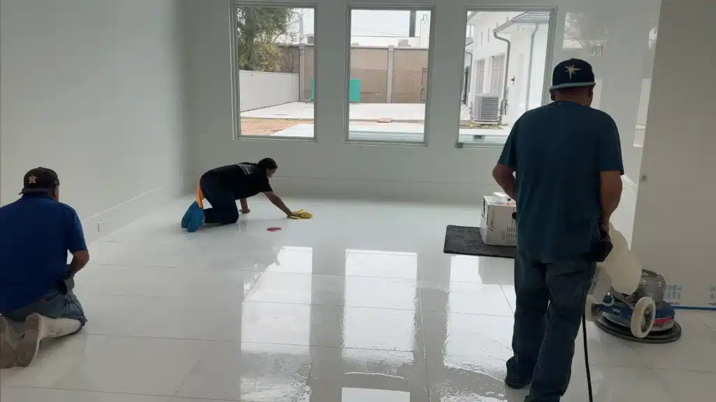 Technicians working on White Thassos marble floor during professional restoration.