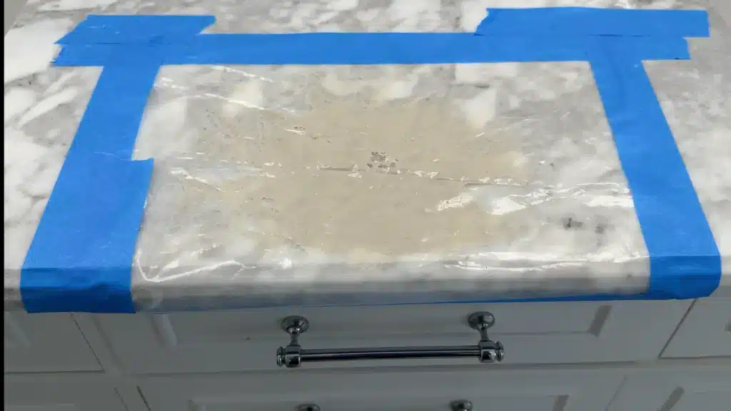 Poultice paste applied to marble countertop stain for removal treatment
