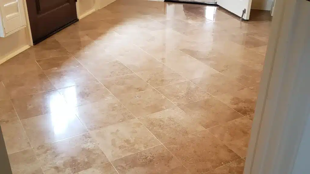 Travertine floor restored and polished in Houston home showing improved shine and uniform finish