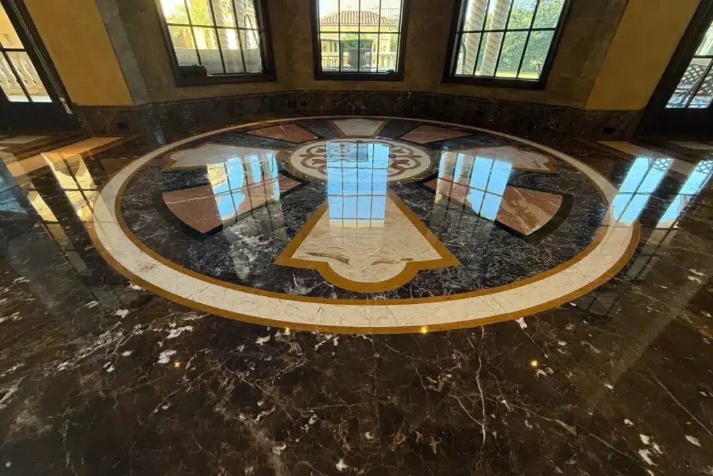 Polished marble floor with decorative medallion after professional refinishing
