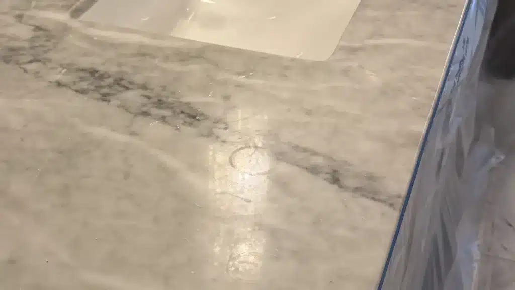 Acid etching ring marks on polished marble countertop
