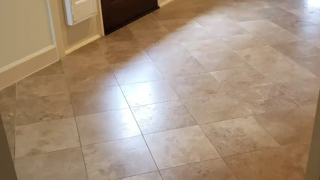 Dull travertine floor in Houston home before professional honing and polishing restoration