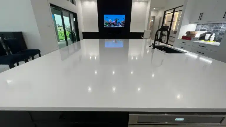 Well maintained white quartz kitchen countertop with polished surface